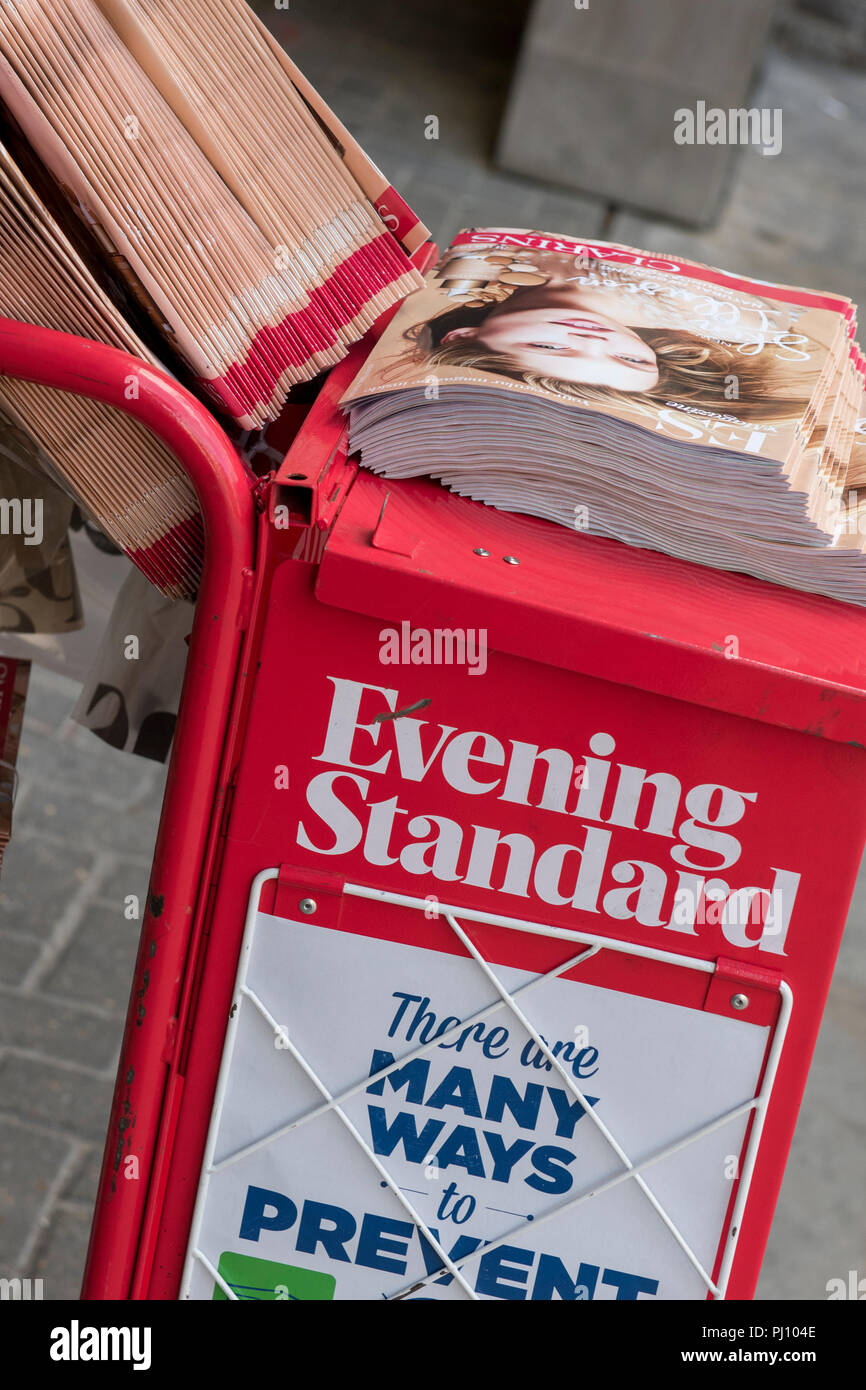the london evening standard newspaper on a stand with a free weekly