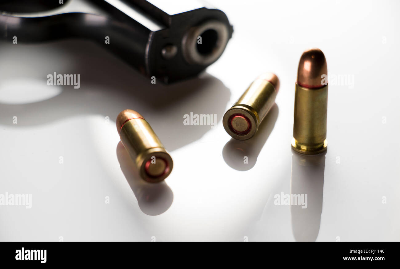 Close up of bullets and a barrel of a gun. Hand gun close up with ammo