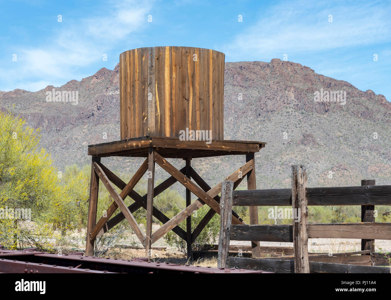 Wooden water tower against a blue sky with clouds Stock Photo - Alamy