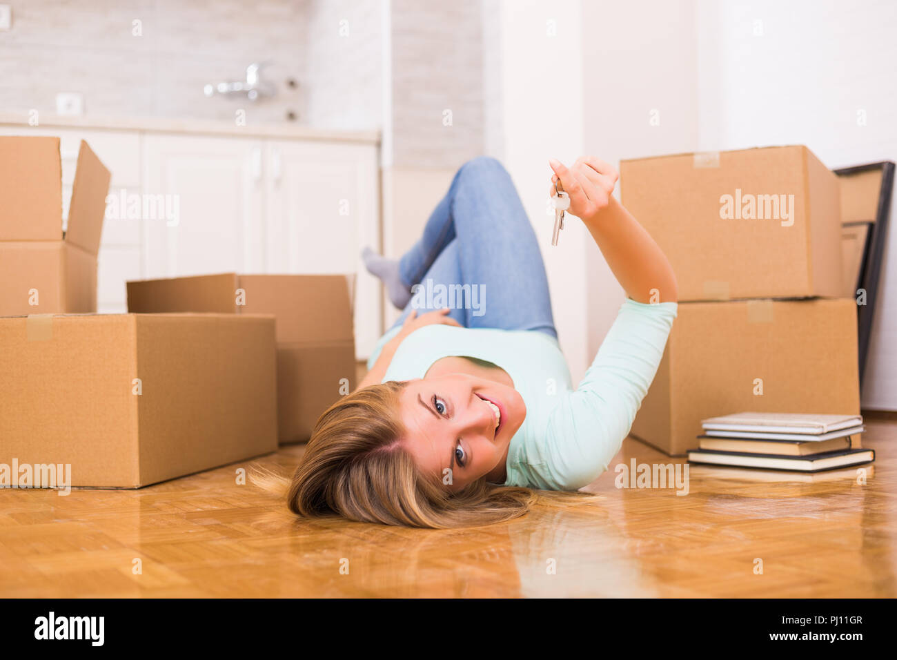 Beautiful woman holding key of her new home Stock Photo - Alamy