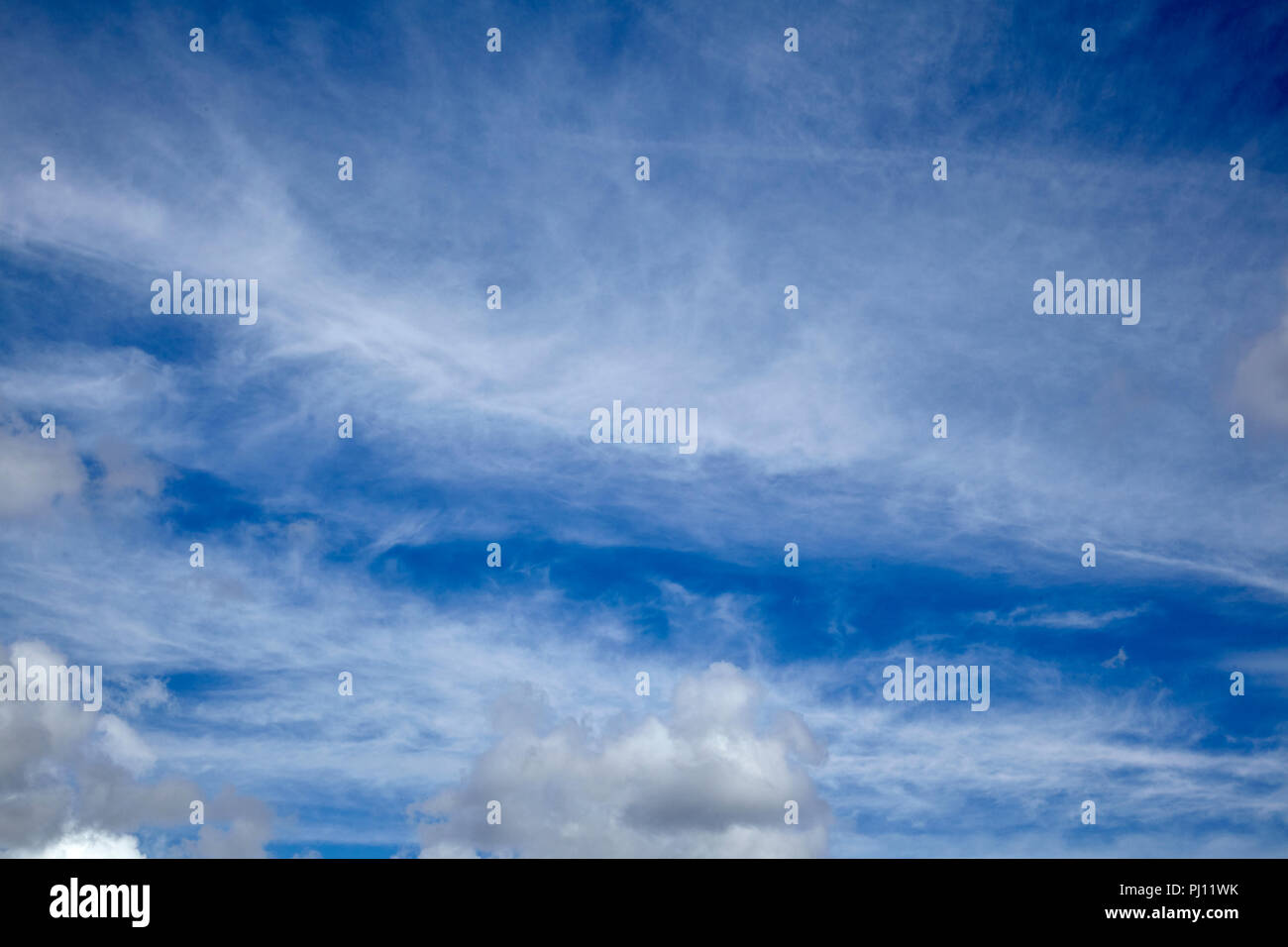 High cirrus and cumulus clouds over daytime sky in England Stock Photo