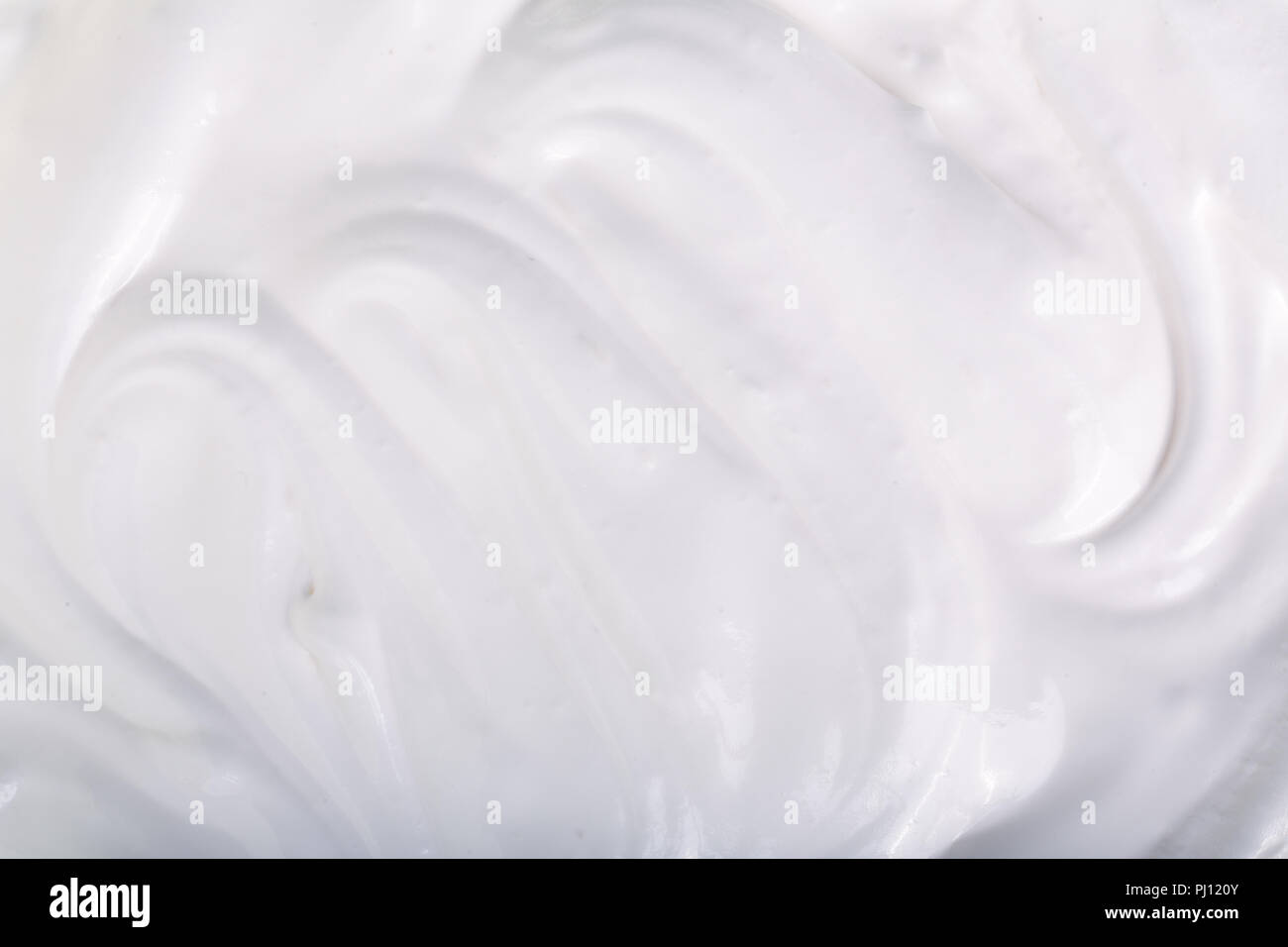 close up of a white whipped or sour cream on white background Stock Photo