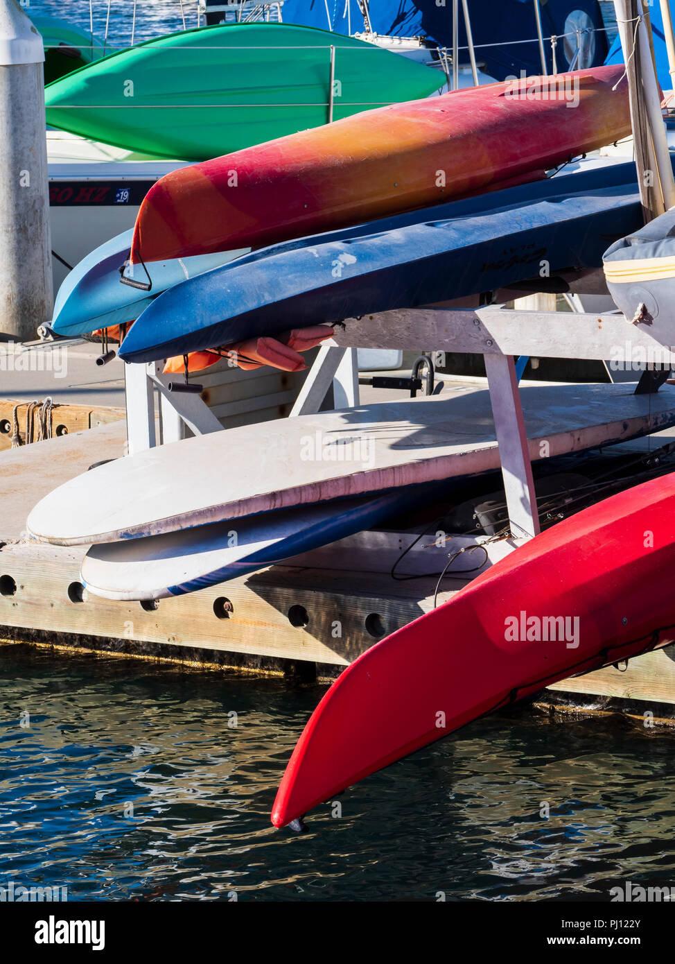 Stacked kayaks and paddle boards, Oceanside Harbor, Oceanside, California. Stock Photo