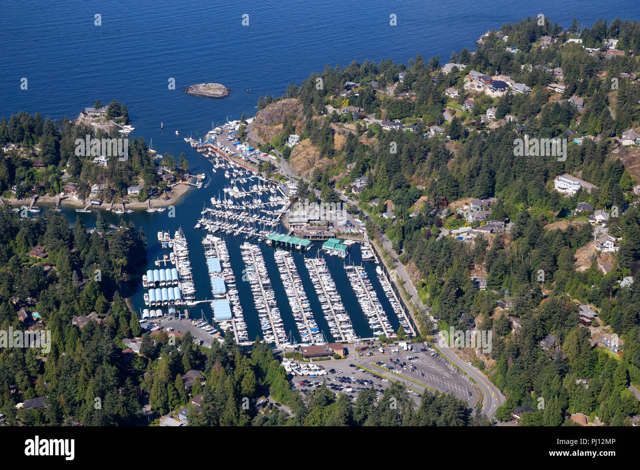 Aerial view of Marina and Residential homes by the ocean shore. Taken