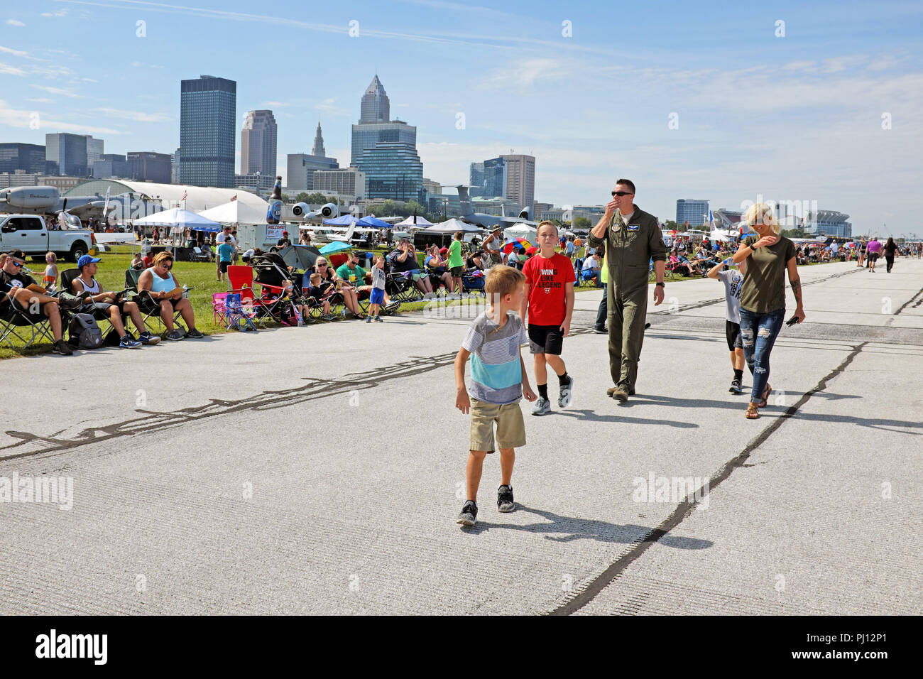 A pilot and his family walk around the 2018 Cleveland National Air Show at Burke Lakefront Airport in downtown Cleveland, Ohio, USA. Stock Photo