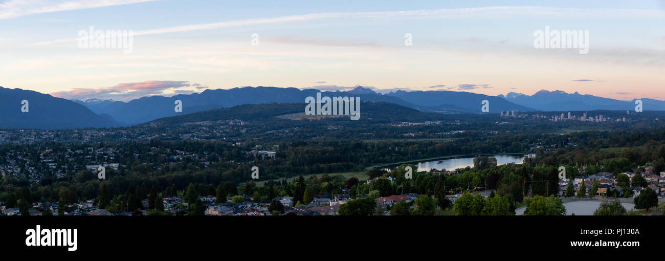 Aerial panoramic view of the modern city during a vibrant summer sunset
