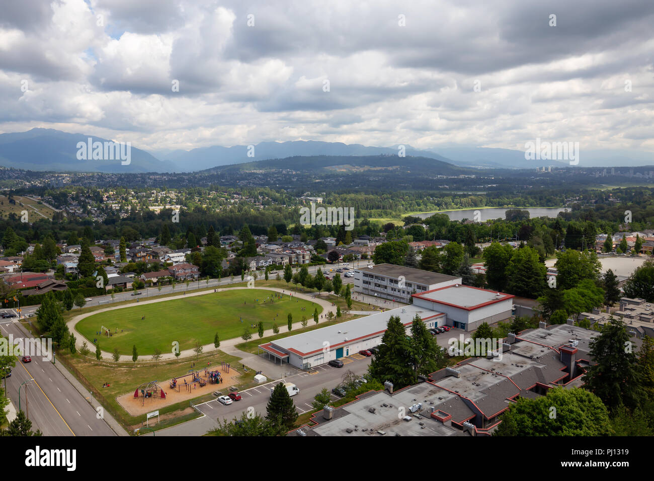 Burnaby, Vancouver, British Columbia, Canada - June 27, 2018: Aerial view of an Elementary School in the suburban area during a vibrant cloudy summer  Stock Photo