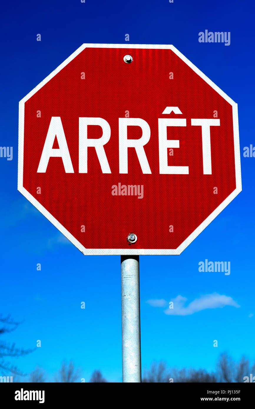 Stop sign in French against a deep blue sky, province of Quebec, Canada