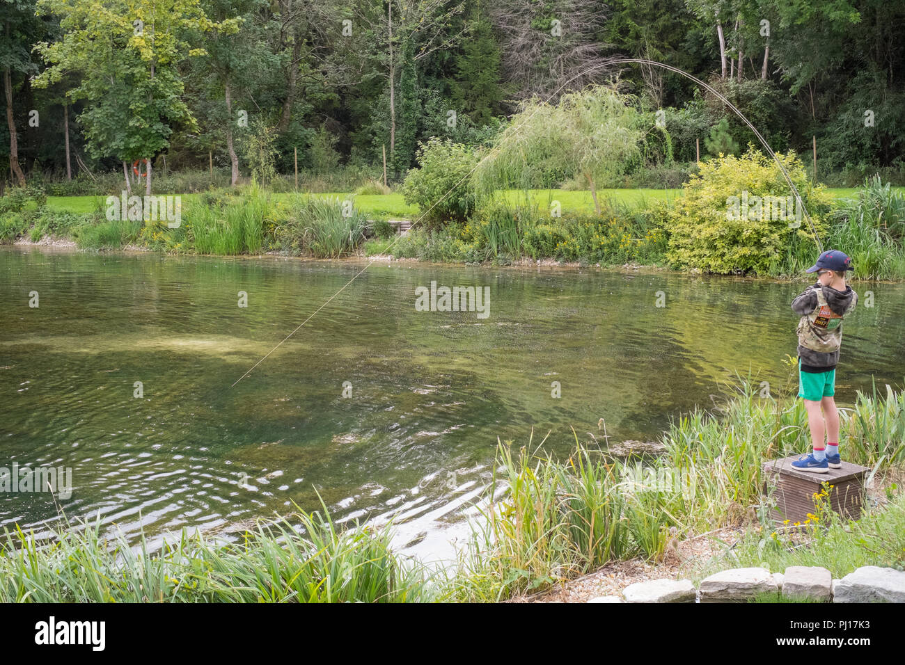 Nine year old boy trout fishing at Church Paddock Trout Fishery