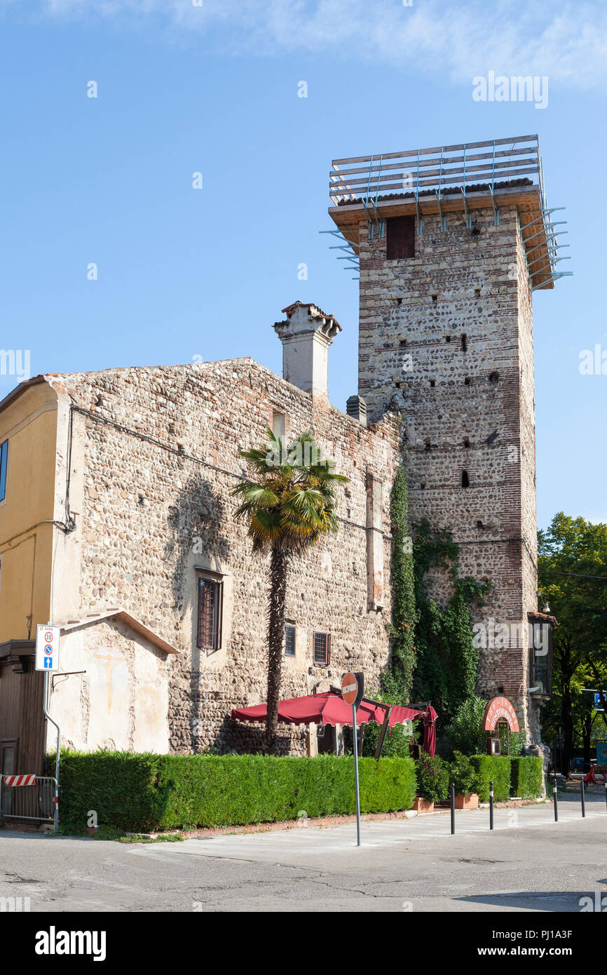 Medieval stone tower on Trevisani Ristorante, Bassano del Grappa, Vicenza, Italy. Picturesque restaurant entrance in morning light. Street view. Stock Photo