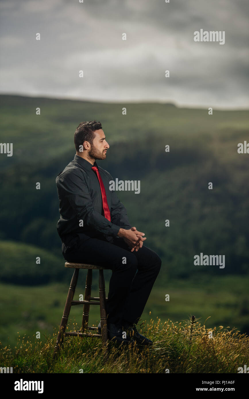 Portrait of a man sitting on a chair, Ireland Stock Photo