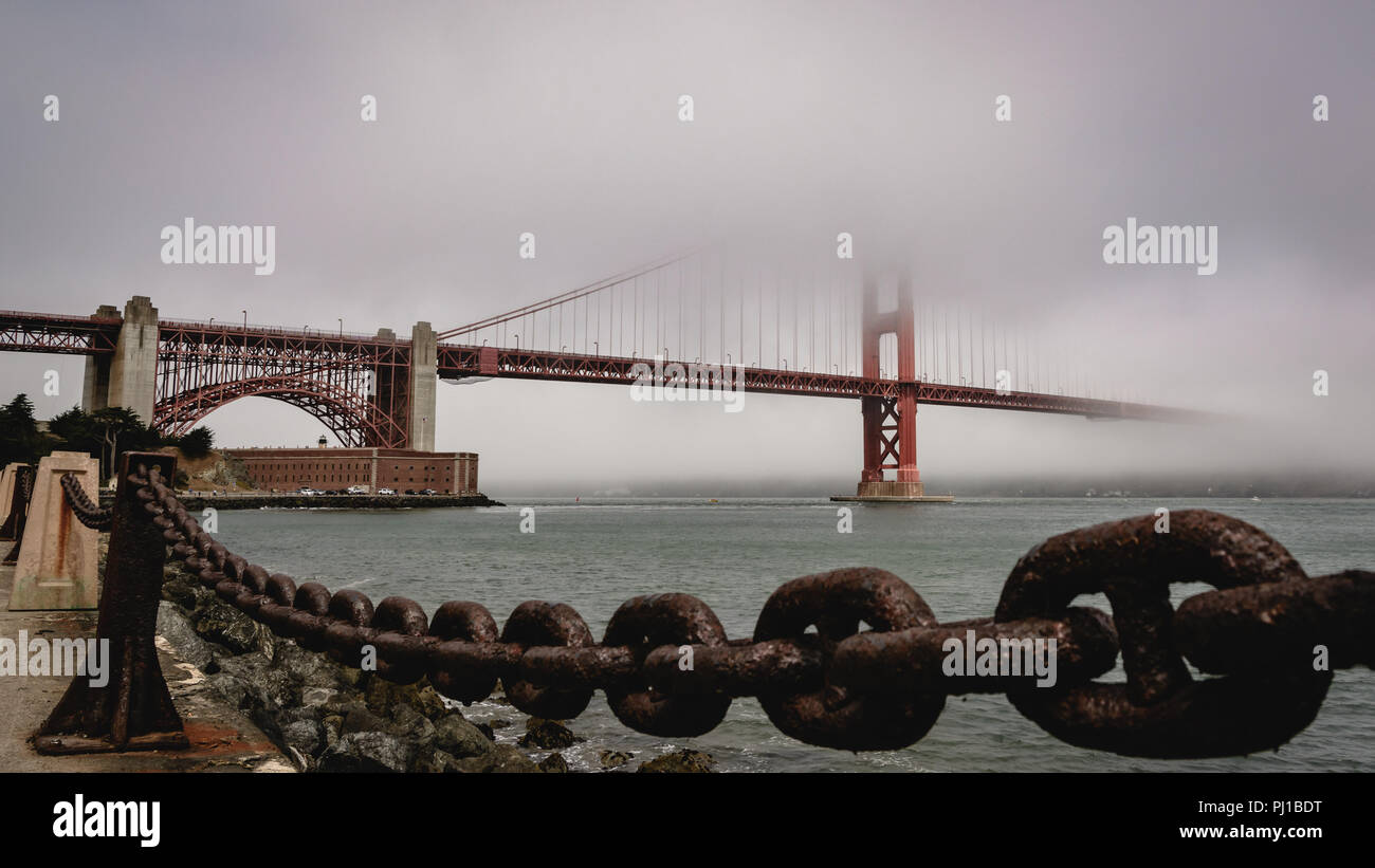 Golden Gate Bridge in the Fog With Fort Point in the Distance Stock Photo