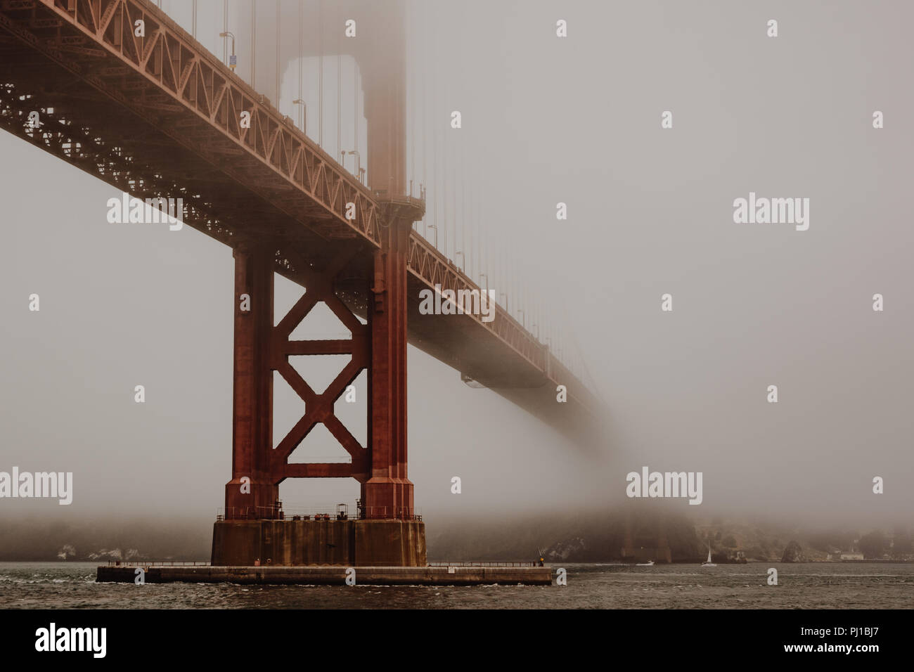 Golden Gate Bridge in the Fog Viewed From Hoppers Hands at Fort Point Stock Photo
