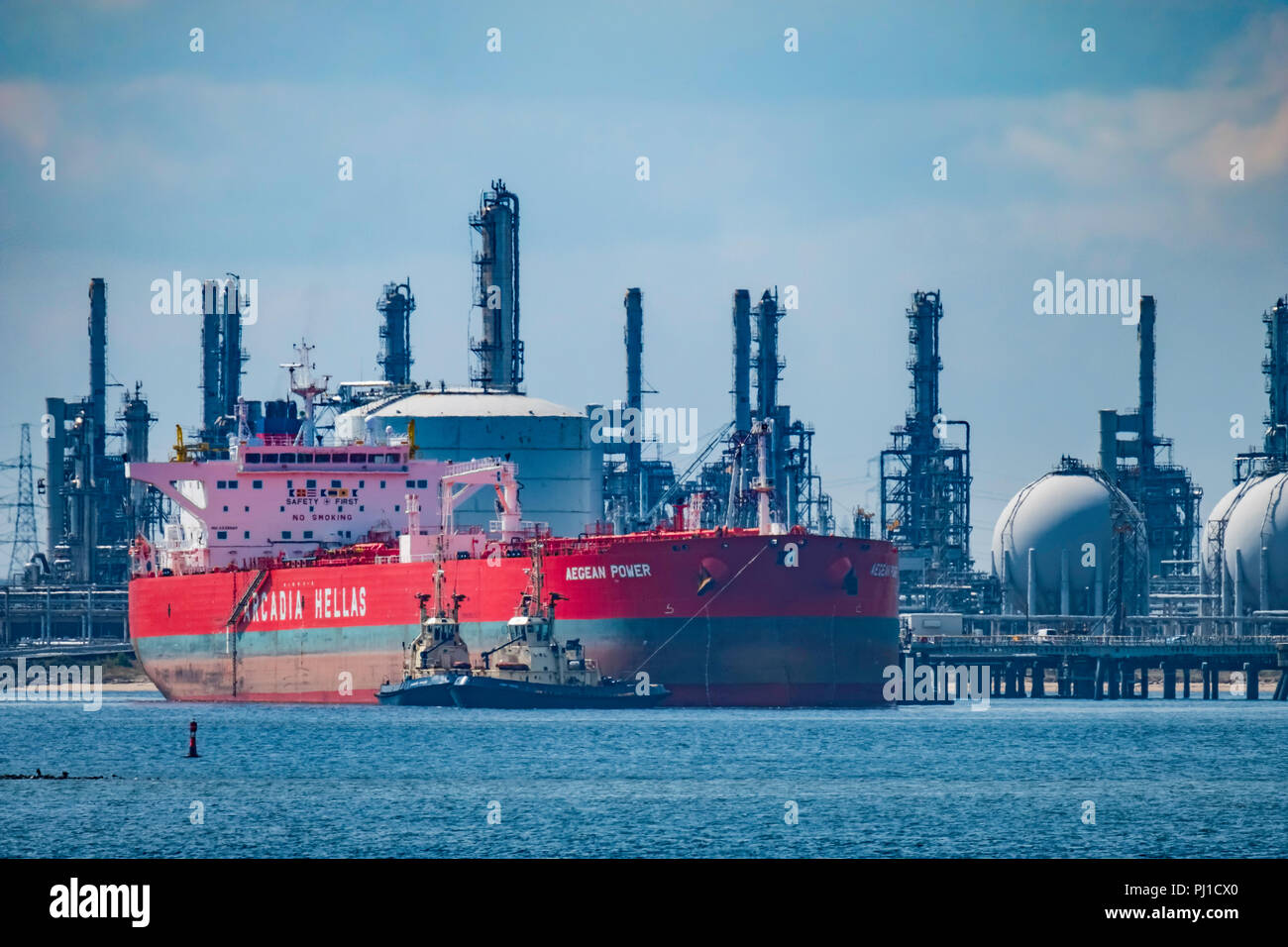 The crude oil tanker Aegean Power with a deadweight of 115,754 tons is brought into Seal Sands port by four tugs. Stock Photo