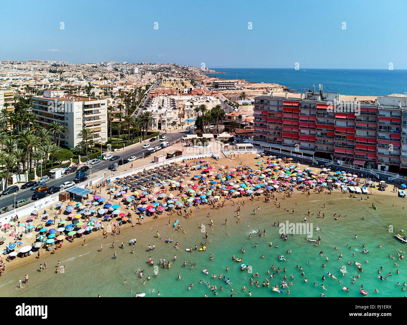 Torrevieja, Spain - August 23, 2018: Aerial panoramic view of beach and Torrevieja cityscape. Lot of people, tourist sunbathing and swimming Stock Photo