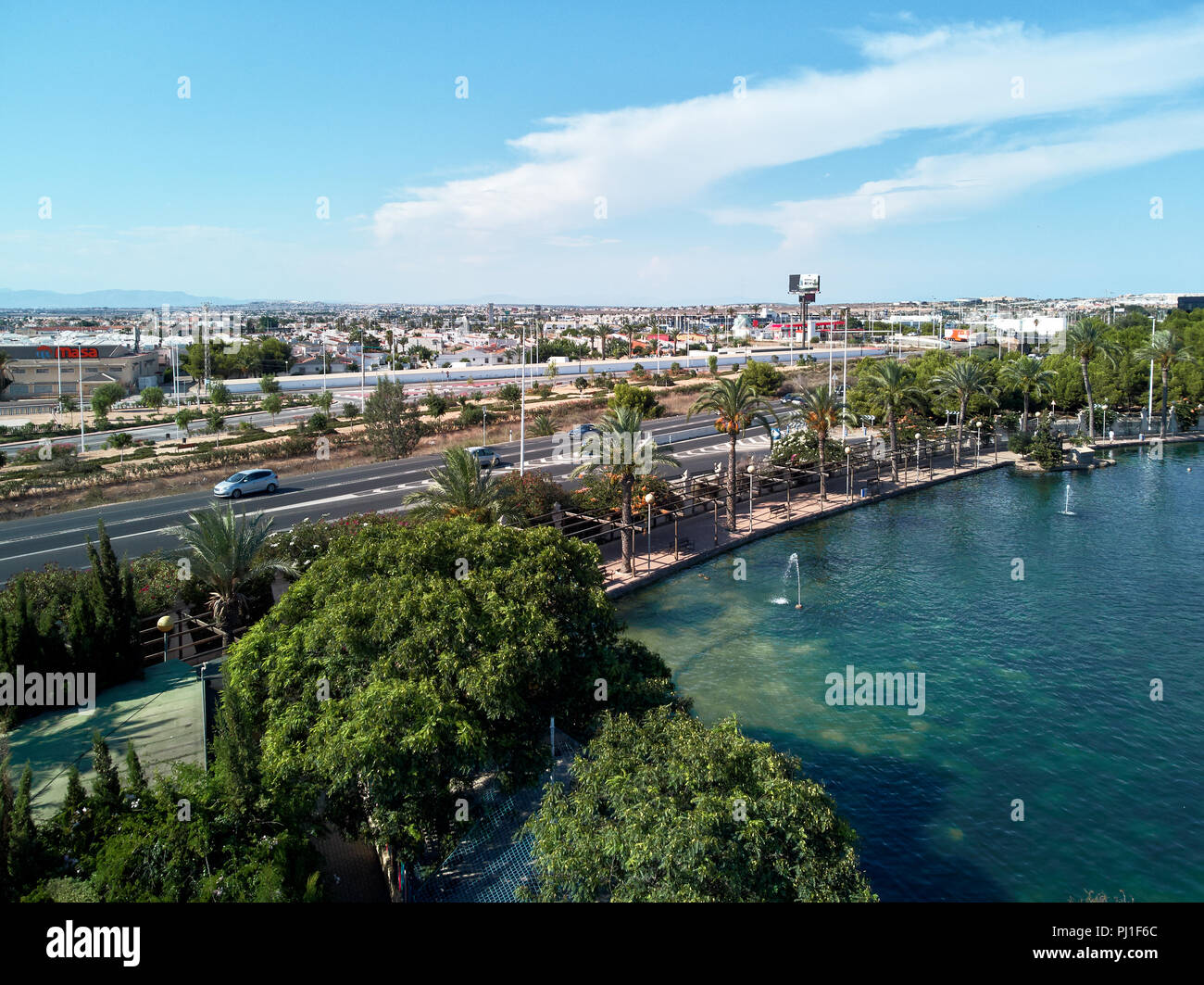 Day view of Park of Nations and Torrevieja cityscape. Urban scene, cars on highway.  Alicante. Costa Blanca. Spain Stock Photo