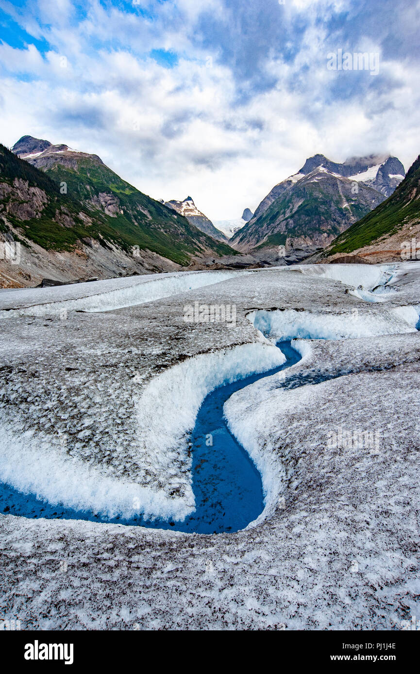Glacier helicopter tour - Juneau Alaska - cruise ship excursion over the Juneau icefield landing on Gilkey Glacier - stunning blue glacial meltwater Stock Photo