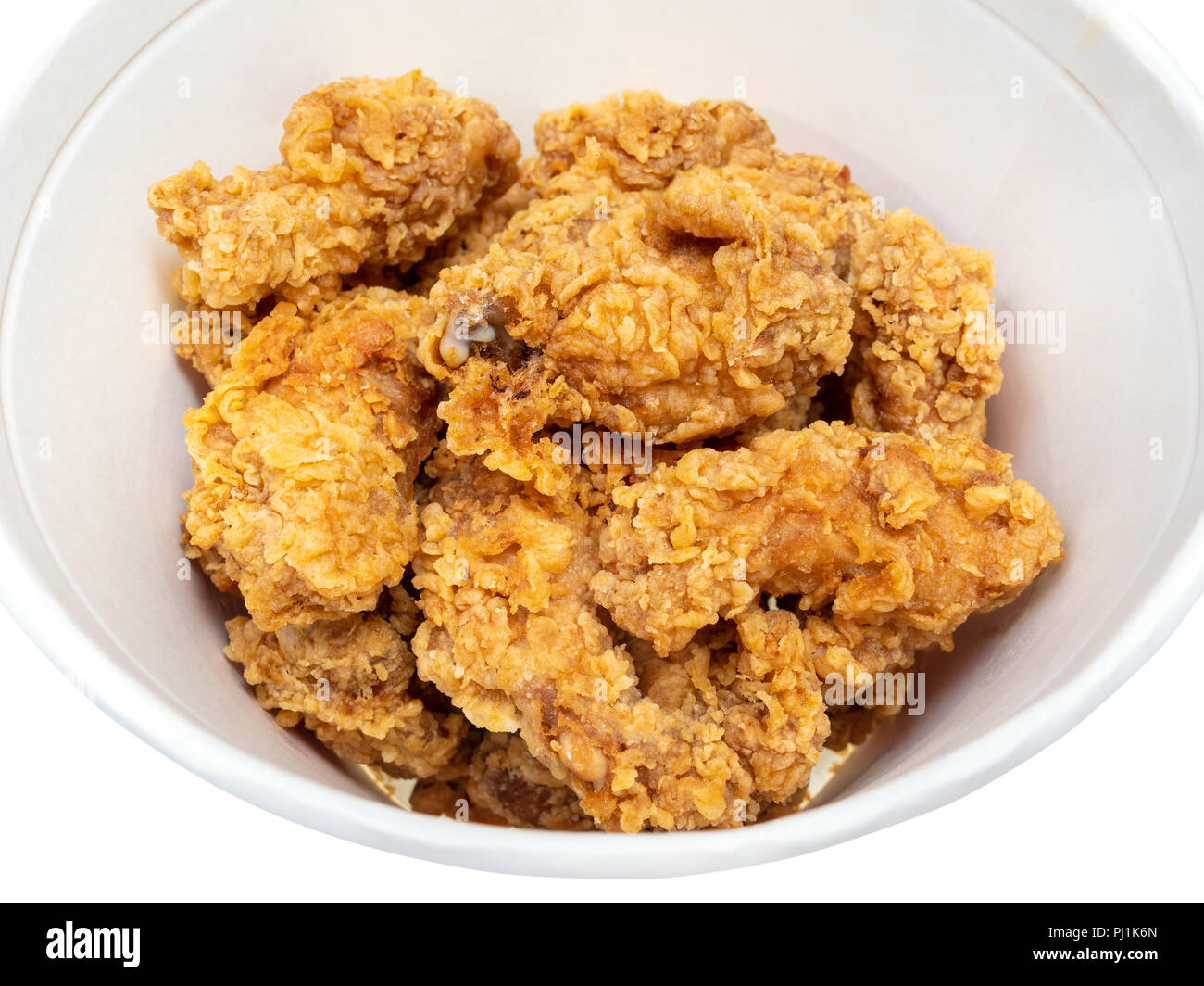 roasted spicy chicken wings close up in bucket cut out on white Stock