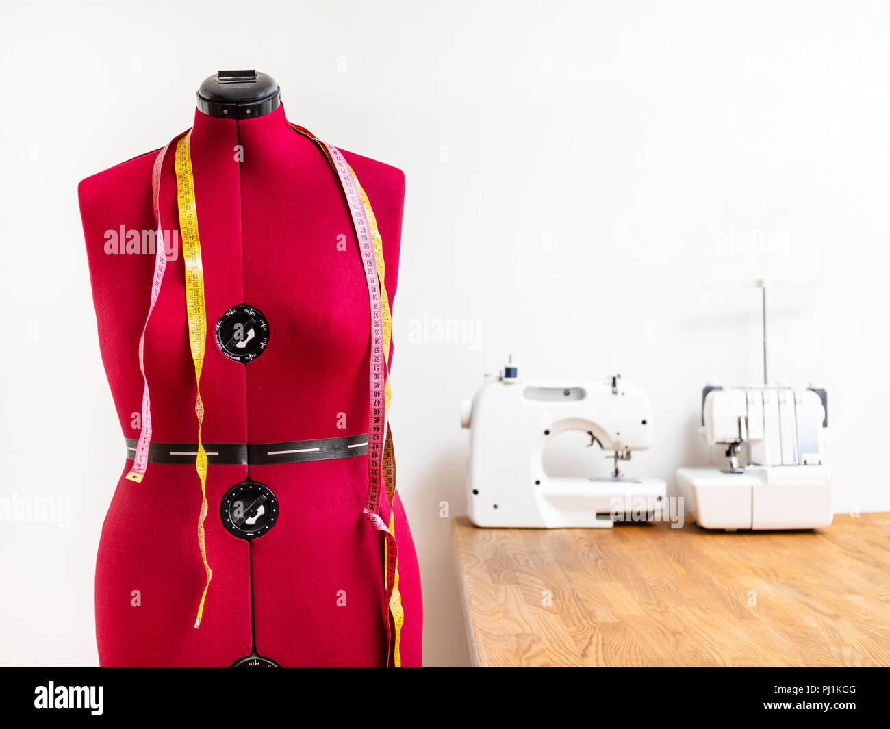 front view tailor's dummy with two measuring tapes in dressmaker Stock Photo Alamy