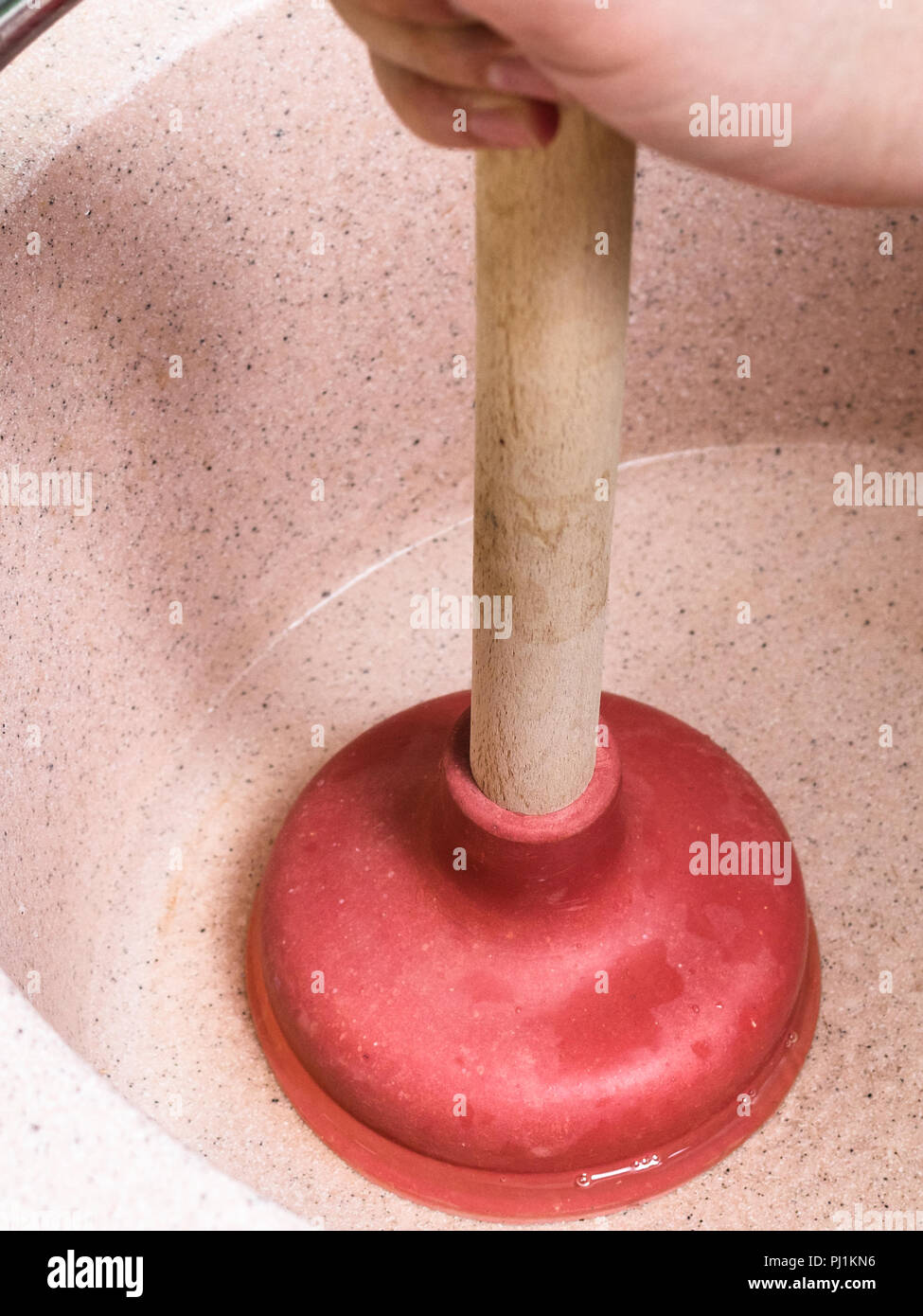 Man Clears Water Blockage In Pink Kitchen Sink By Common