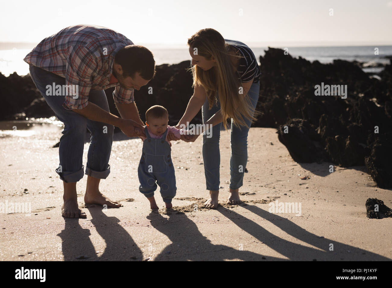 Father teaching baby to walk hi-res stock photography and images - Alamy
