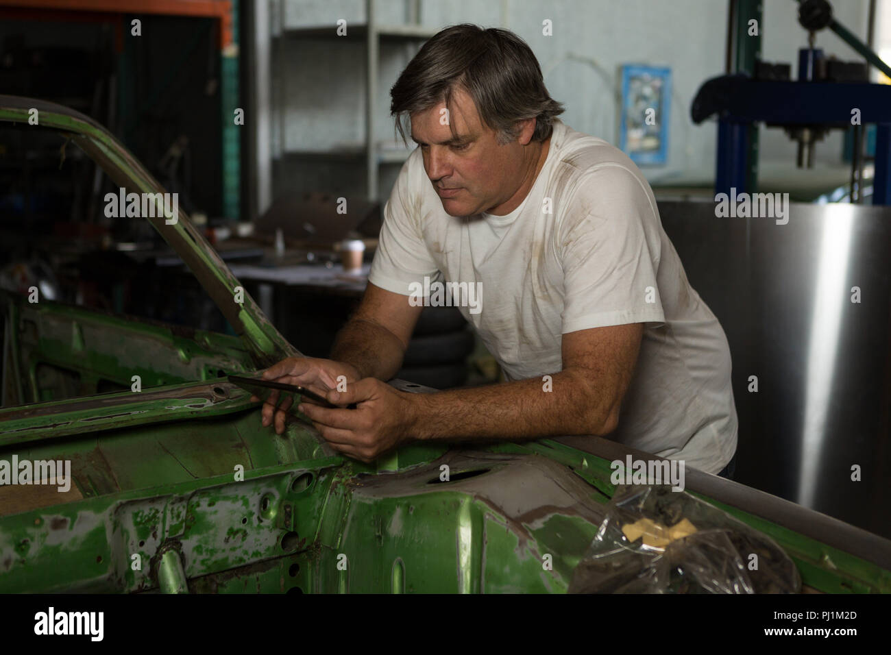 Male mechanic using digital tablet Stock Photo