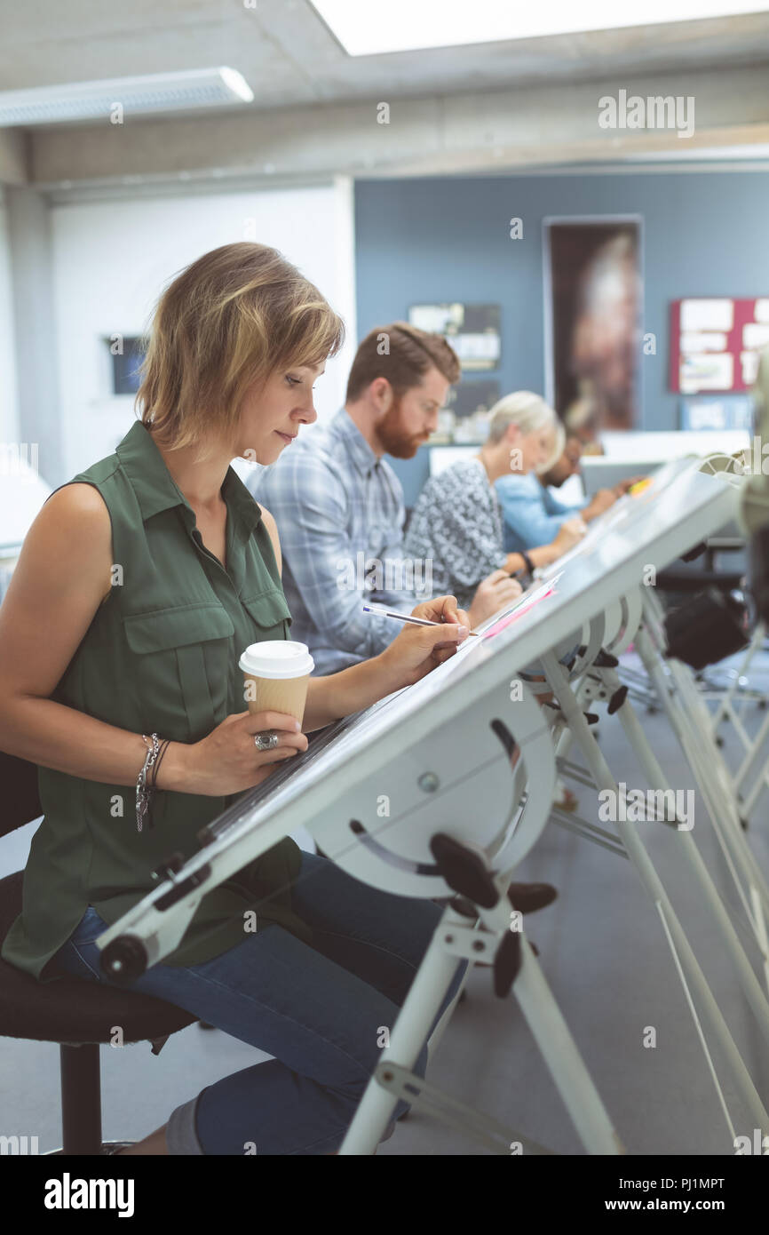 Executives working on drafting table Stock Photo