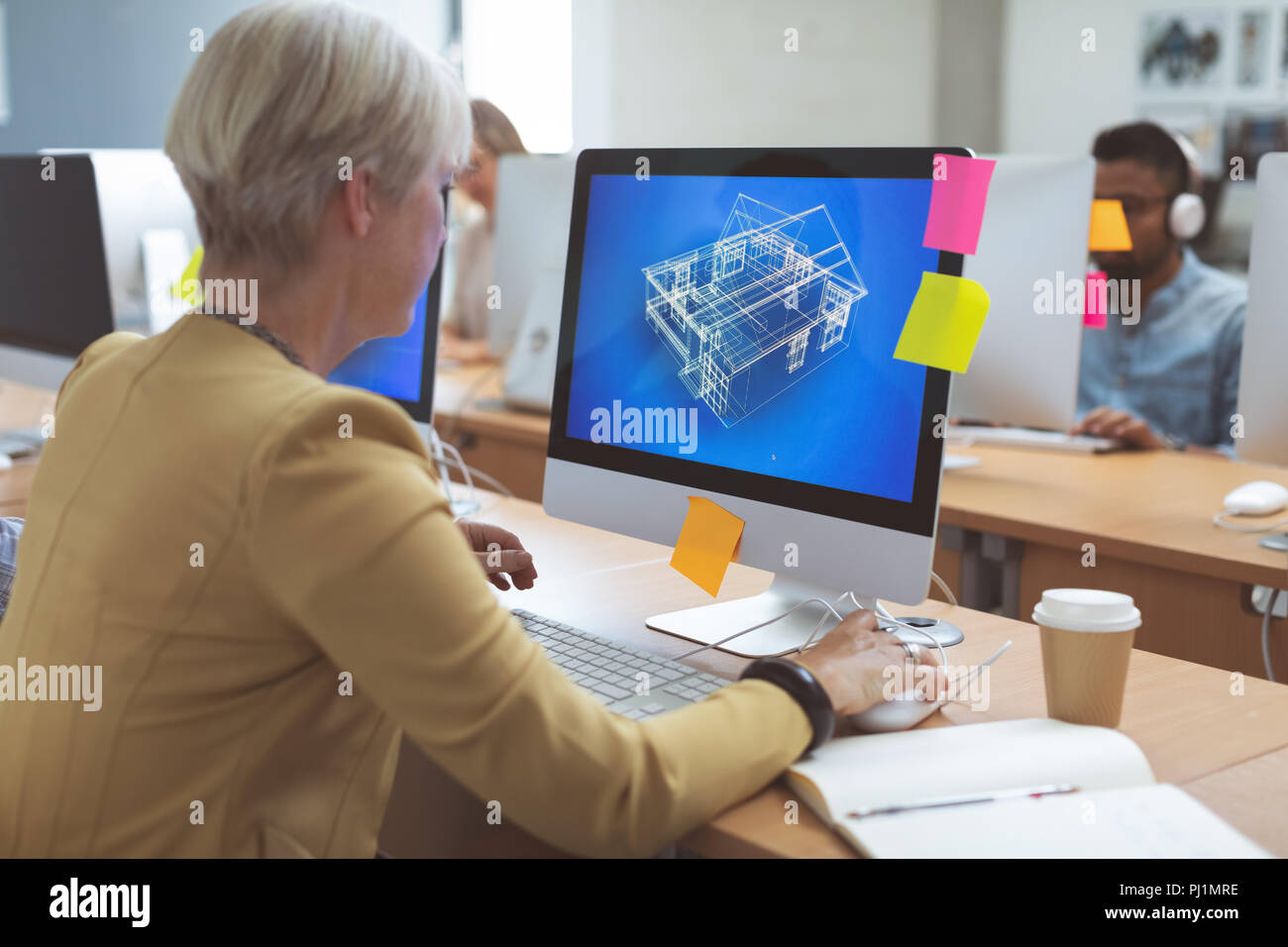 Businesswoman working on desktop pc at desk Stock Photo