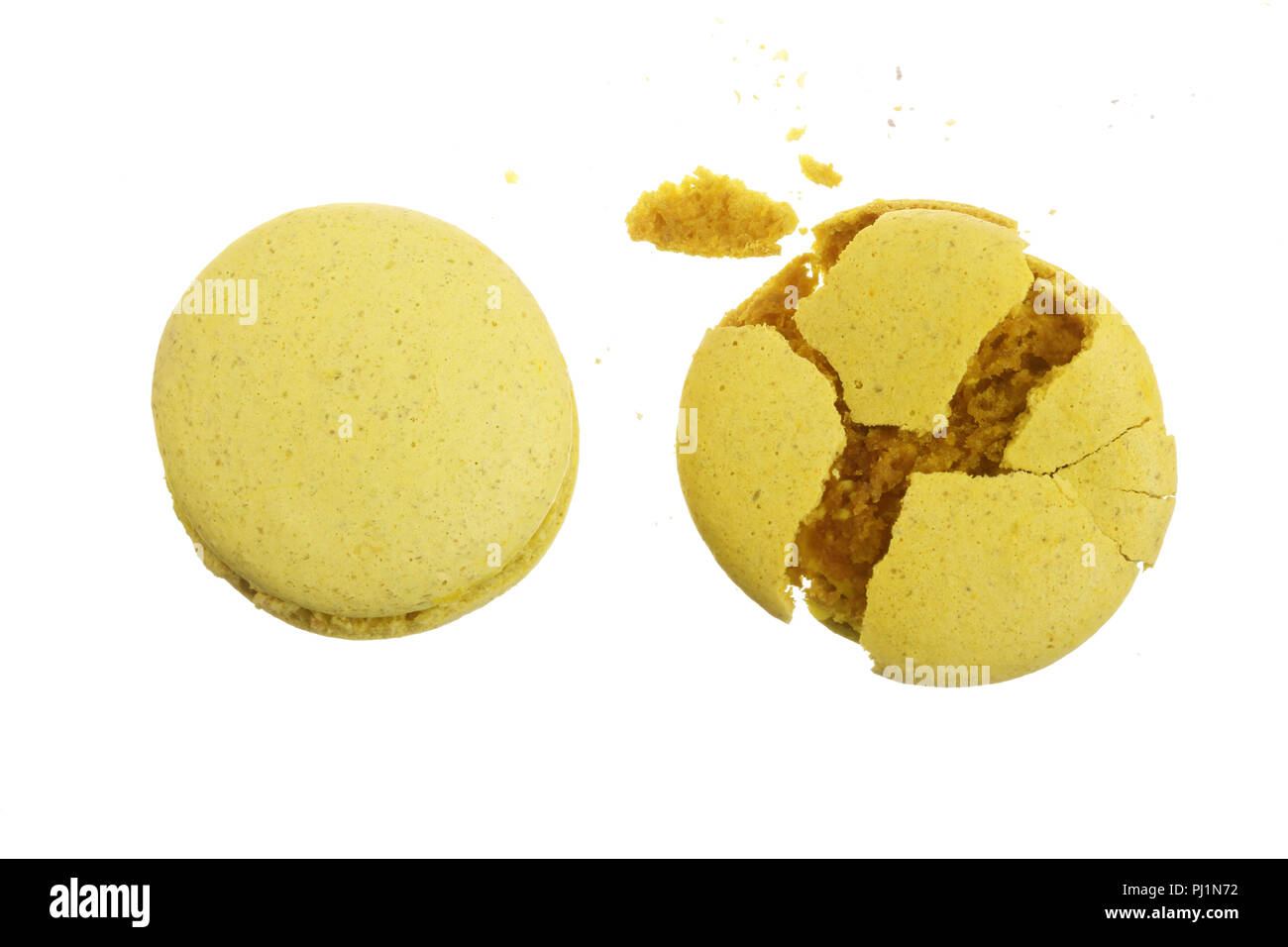 broken yellow macarons isolated on white background closeup. Stock Photo
