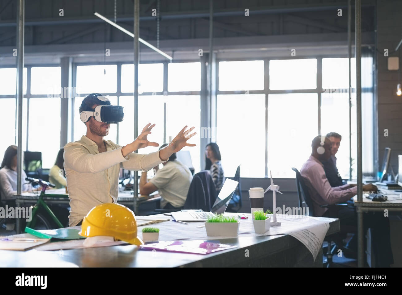 Male executive using virtual reality headset Stock Photo
