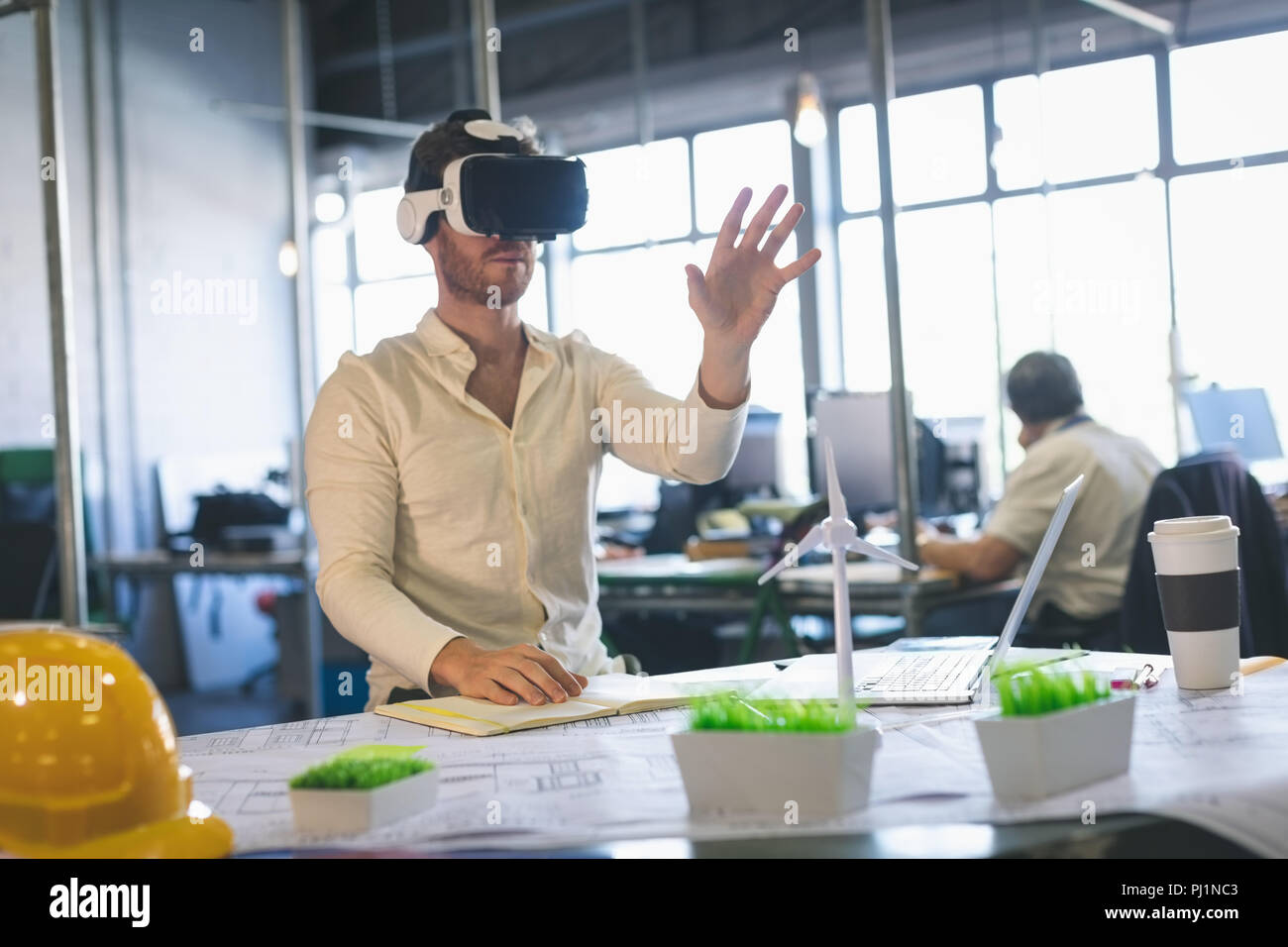 Male executive using virtual reality headset Stock Photo