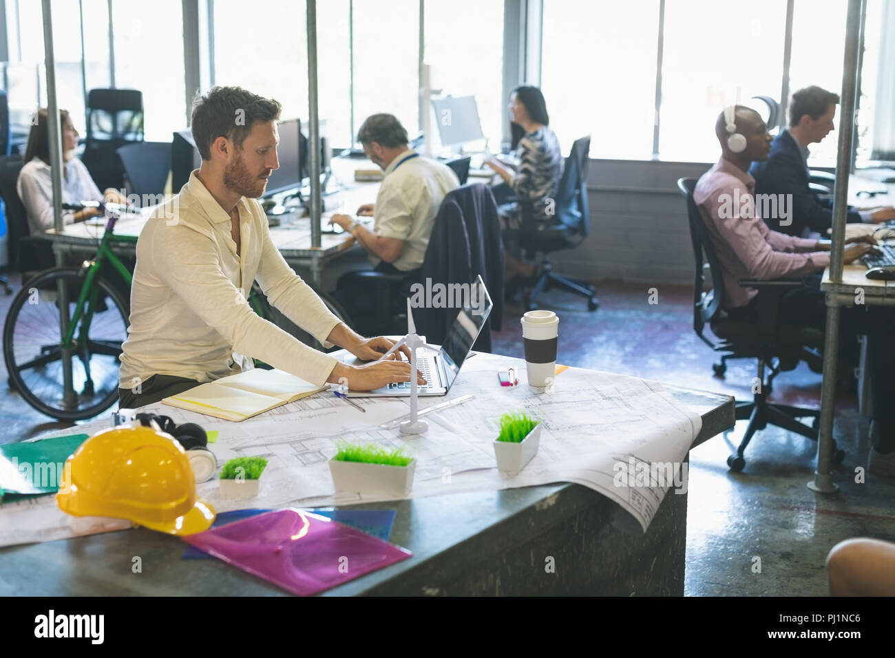 Male executive using laptop at desk Stock Photo