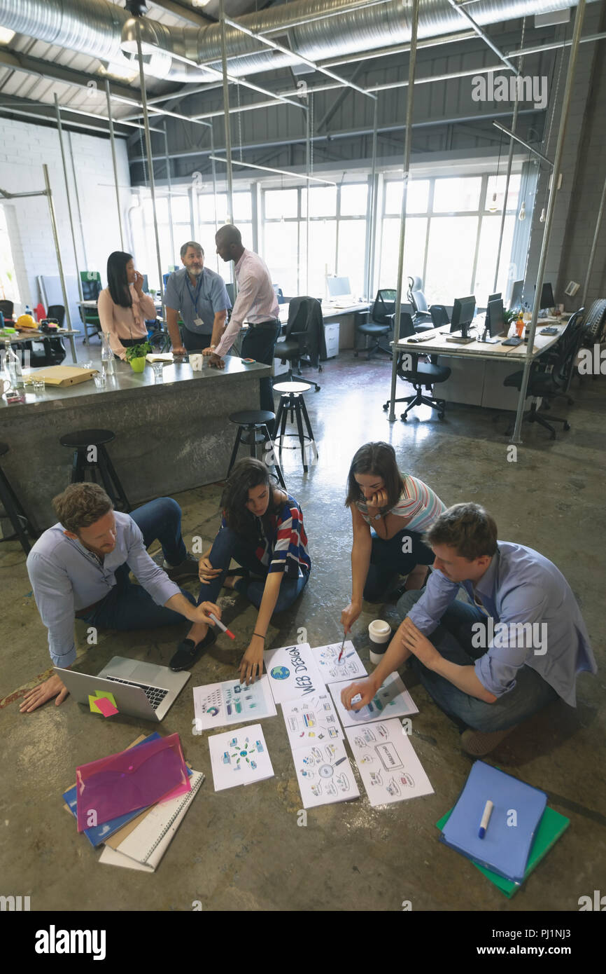 Business people discussing over documents Stock Photo