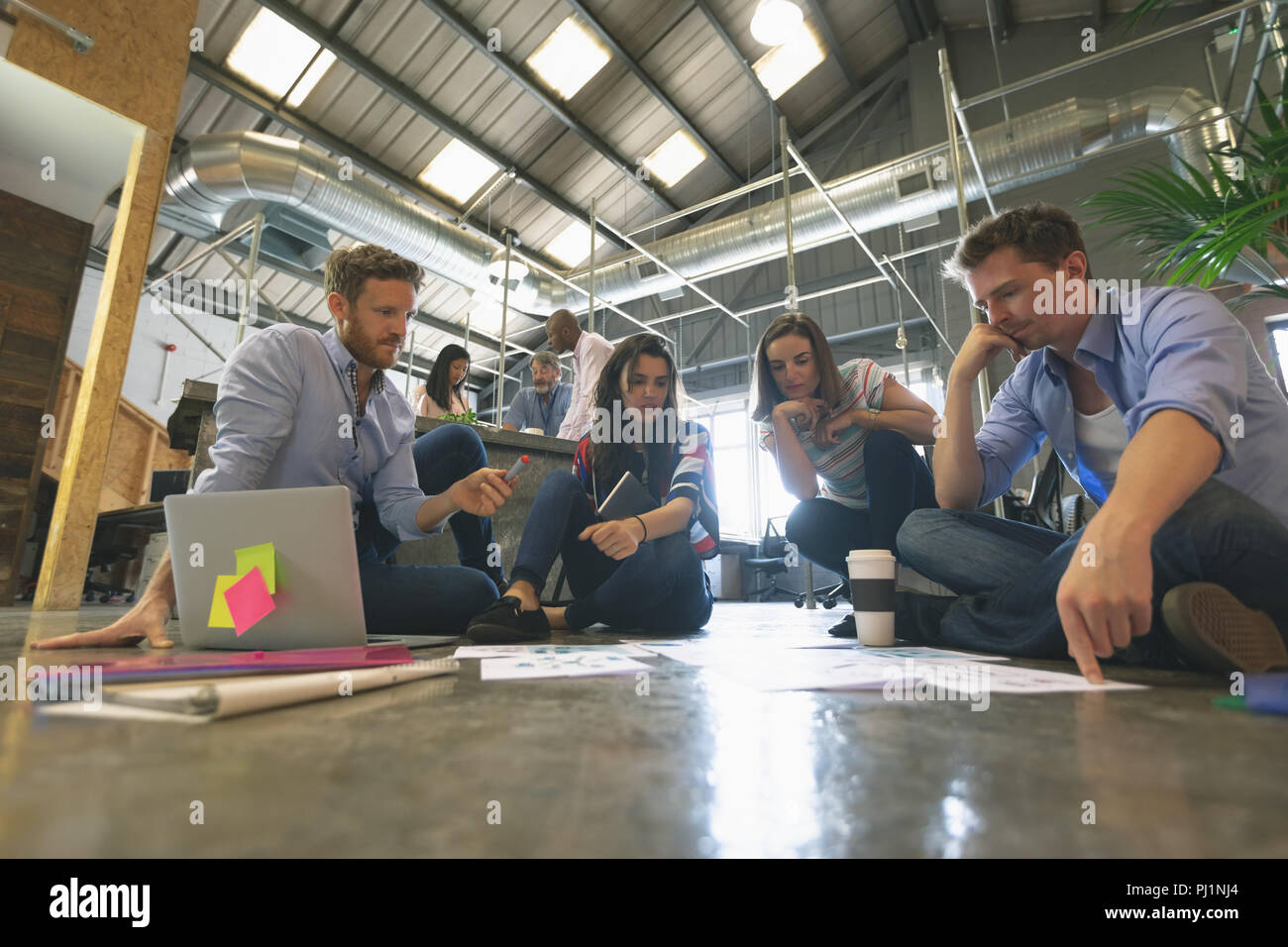 Business people discussing over documents Stock Photo