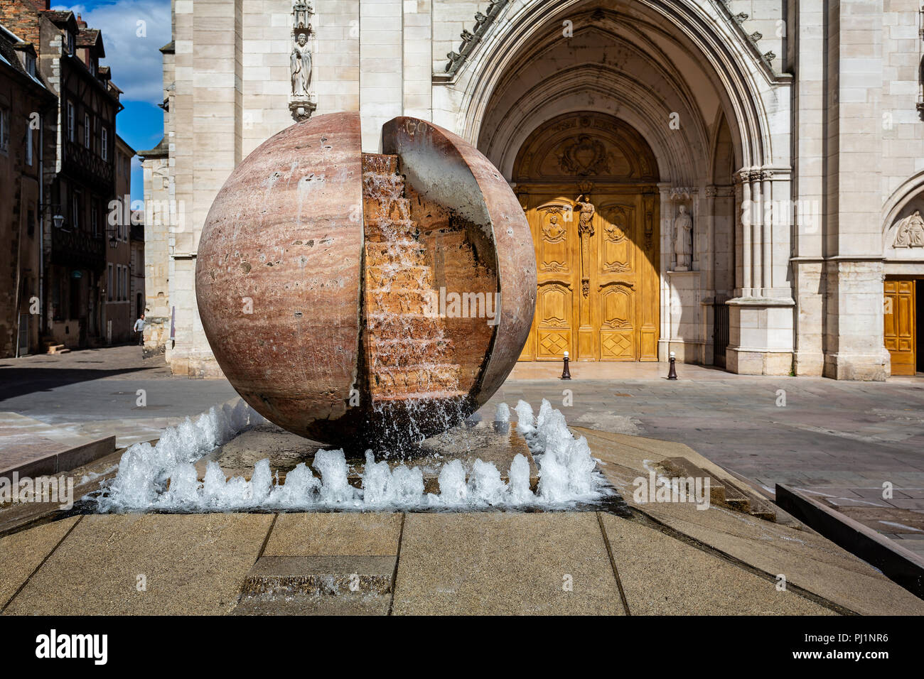 Close up of stone globe with water fall in front of St Vincent Cathedral, Chalon sur Saone, Burgundy, France on 29 August 2018 Stock Photo