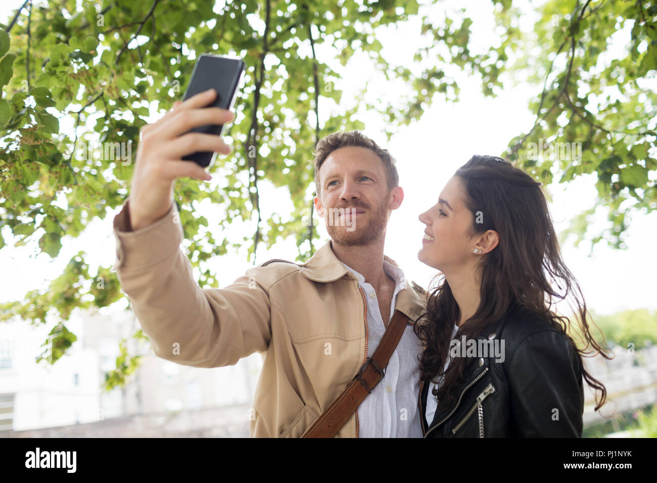 Couple taking selfie near lake side Stock Photo