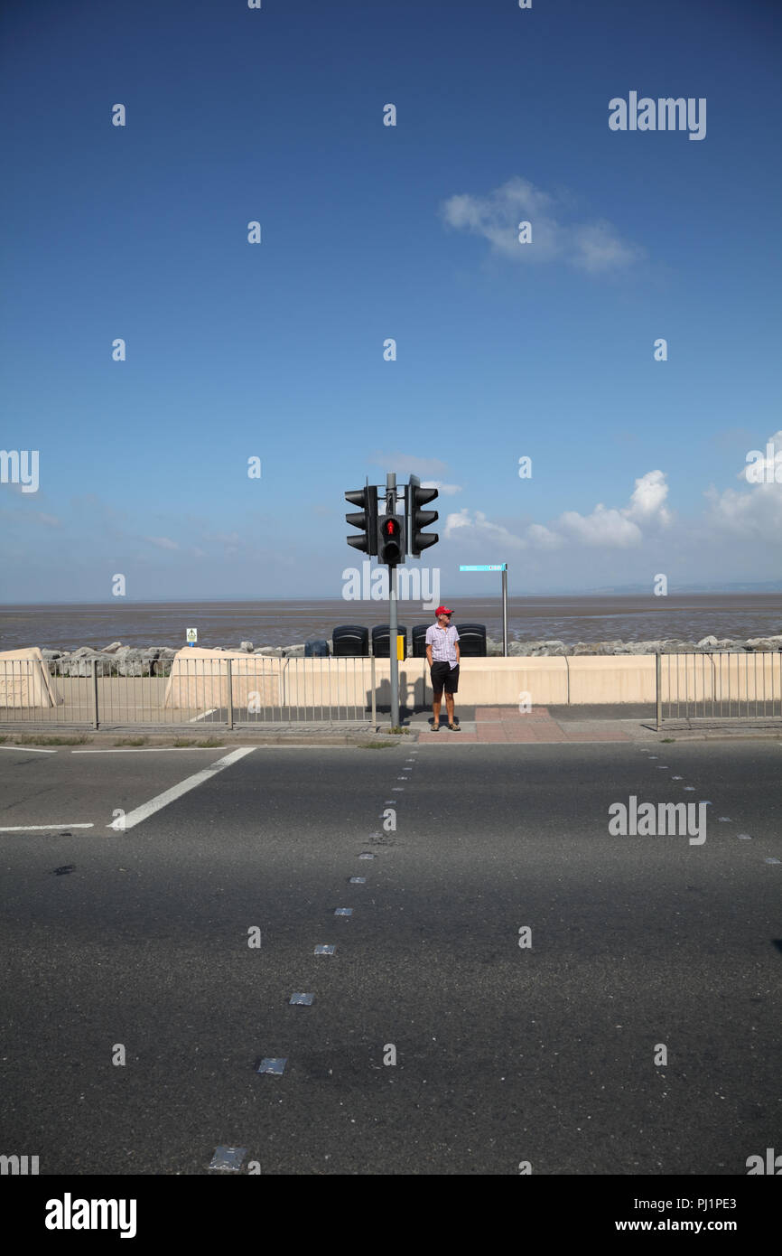 Man standing at pedestrian controlled traffic lights Stock Photo Alamy