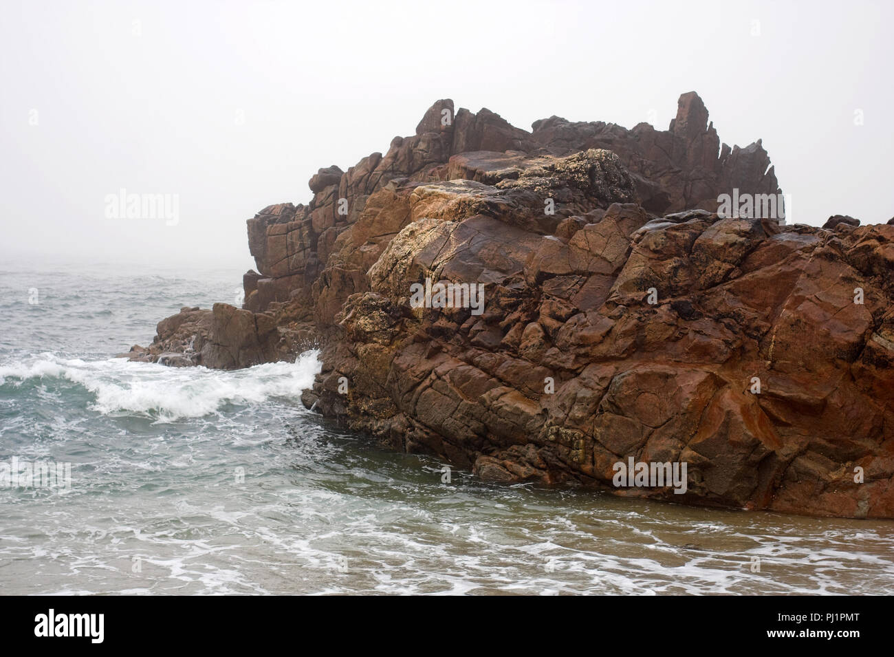 Composition with rock and sea in an early foggy morning Stock Photo