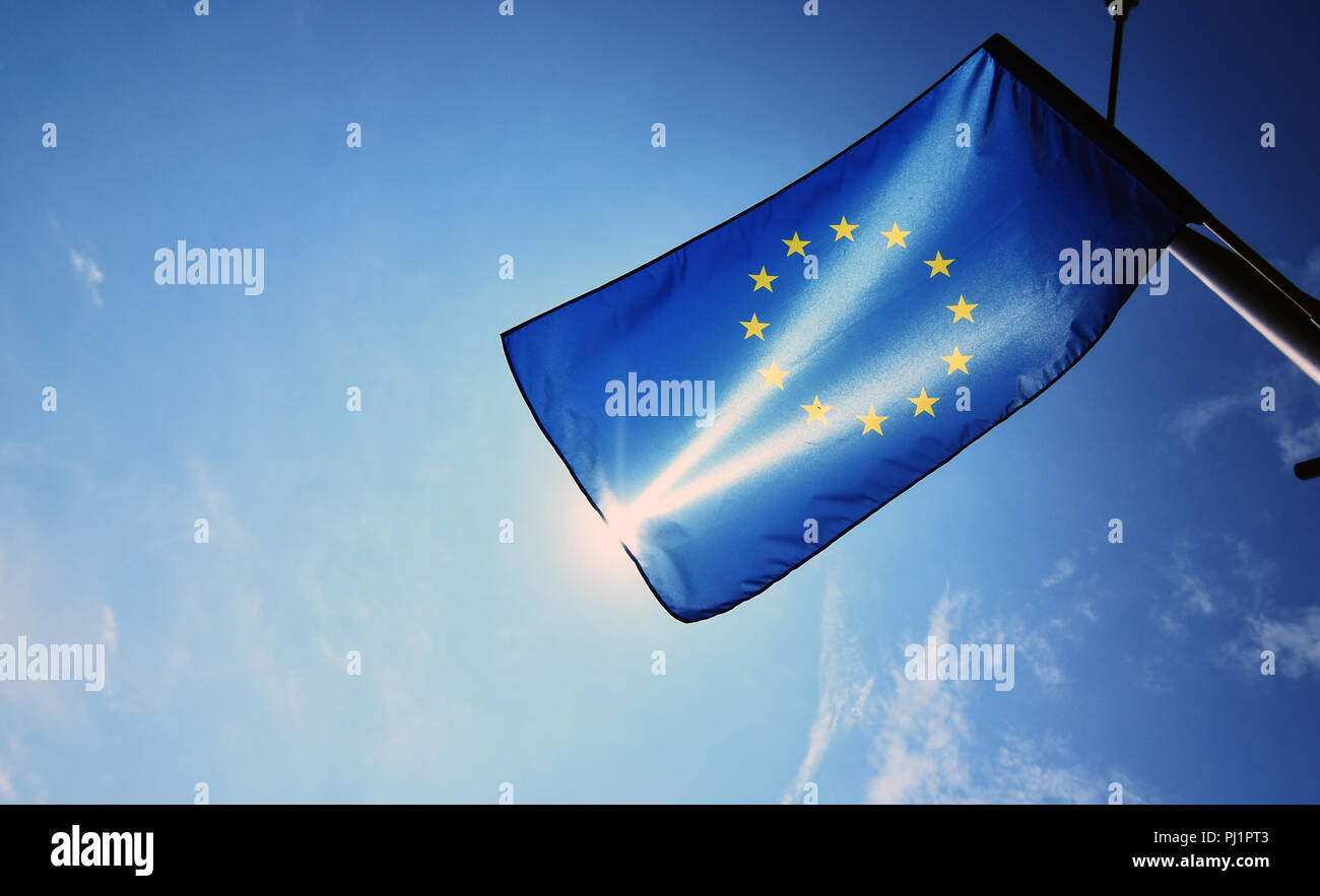European union flag on blue sky and sun background Stock Photo - Alamy