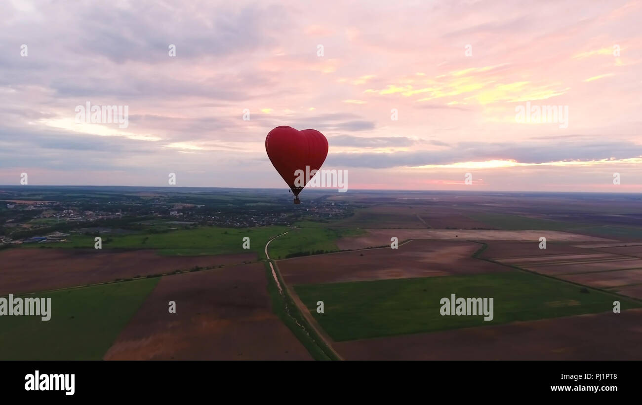 Hot air balloon shape of a heart in the blue sky. Aerostat, Airship ...