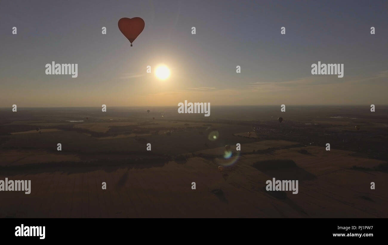 Hot air balloon shape of a heart in the blue sky. Aerostat, Airship ...