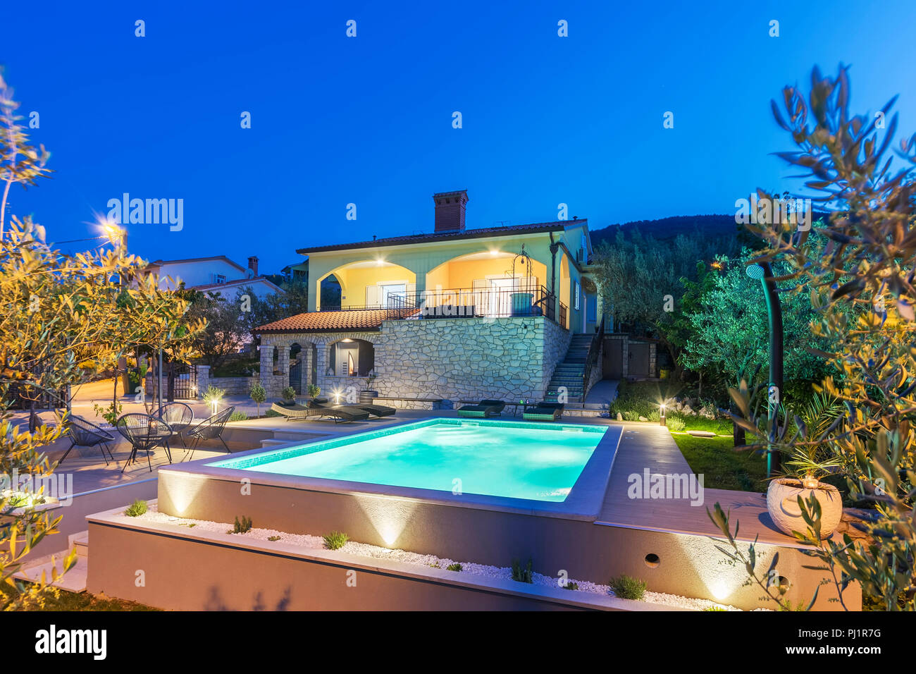 holiday home with swimming pool at night Stock Photo