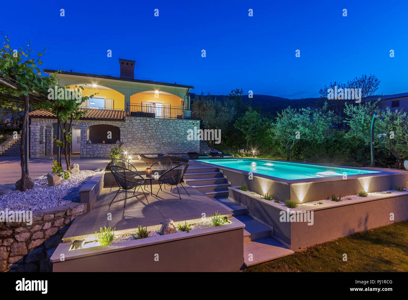 holiday home with swimming pool at night Stock Photo