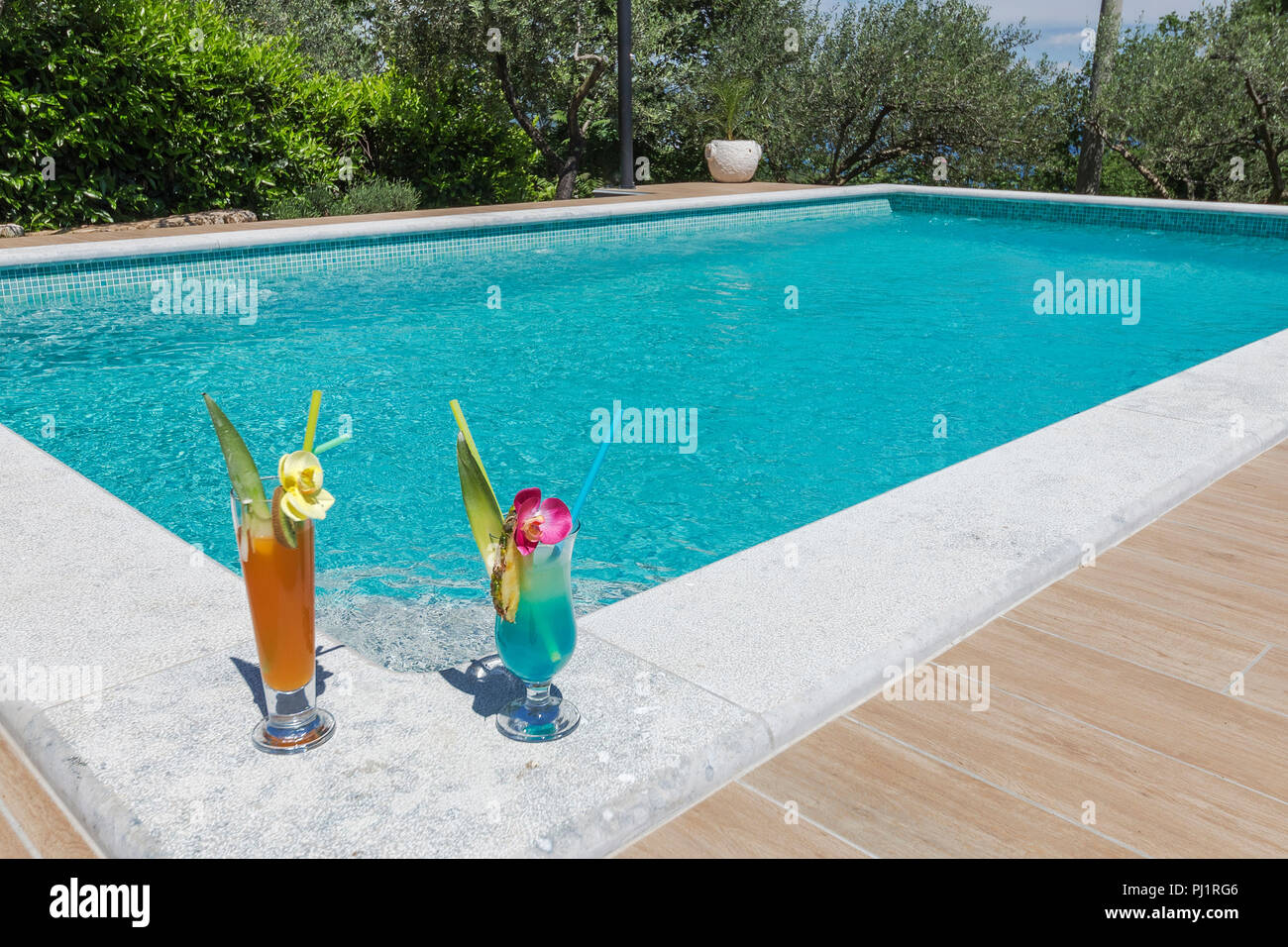 two cocktails at swimming pool corner Stock Photo