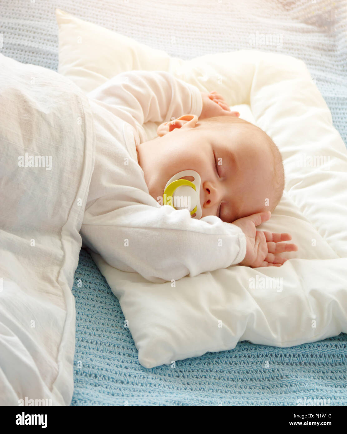 Baby sleeping covered with soft white blanket Stock Photo Alamy