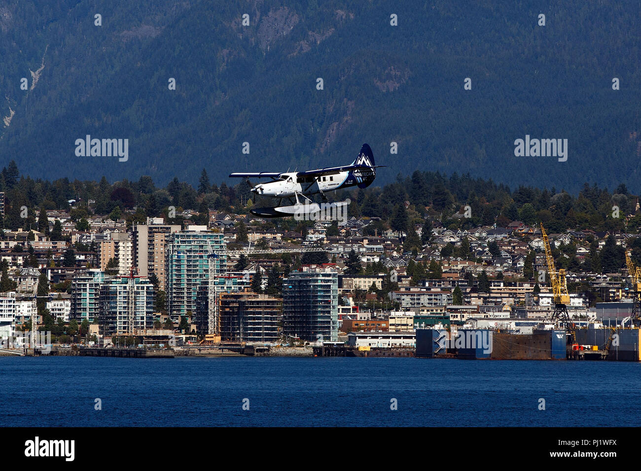 De Havilland Canada DHC-3T Otter (C-GHAZ) operated by Harbour Air with the Vancouver Whitecaps Livery lands in Vancouver Harbor, Vancouver, British Columbia, Canada Stock Photo