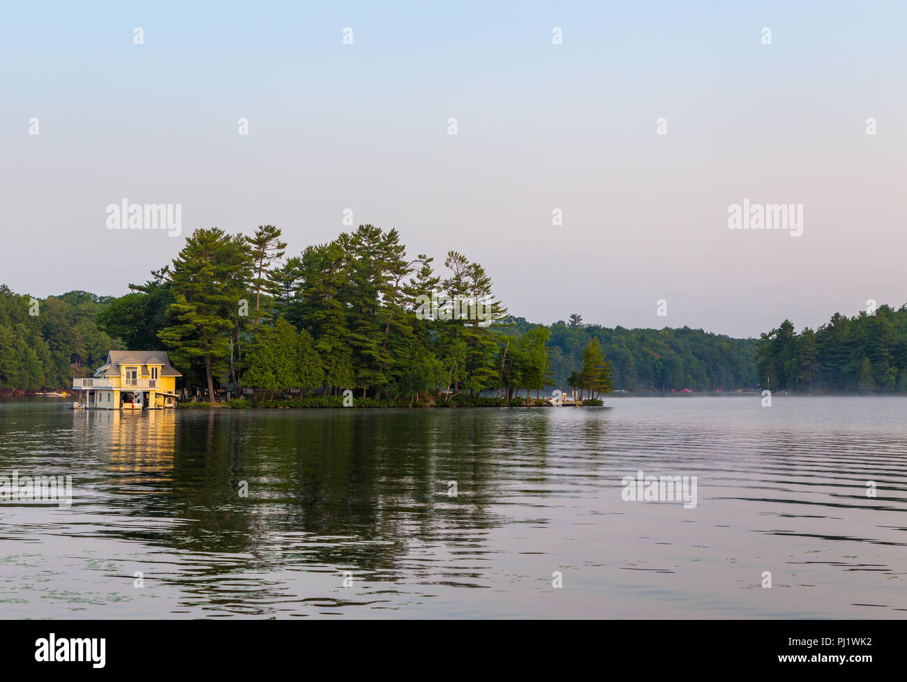 A small lakeside cottage on an Island in the Muskokas, Ontario, at sunrise. Stock Photo