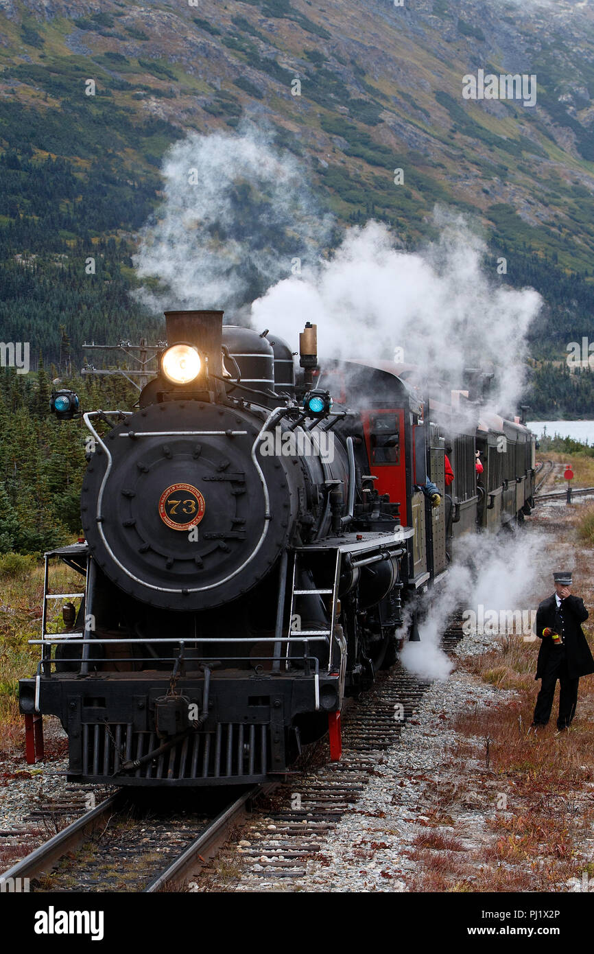 Steam train engine number 73 with conductor, White Pass and Yukon Route