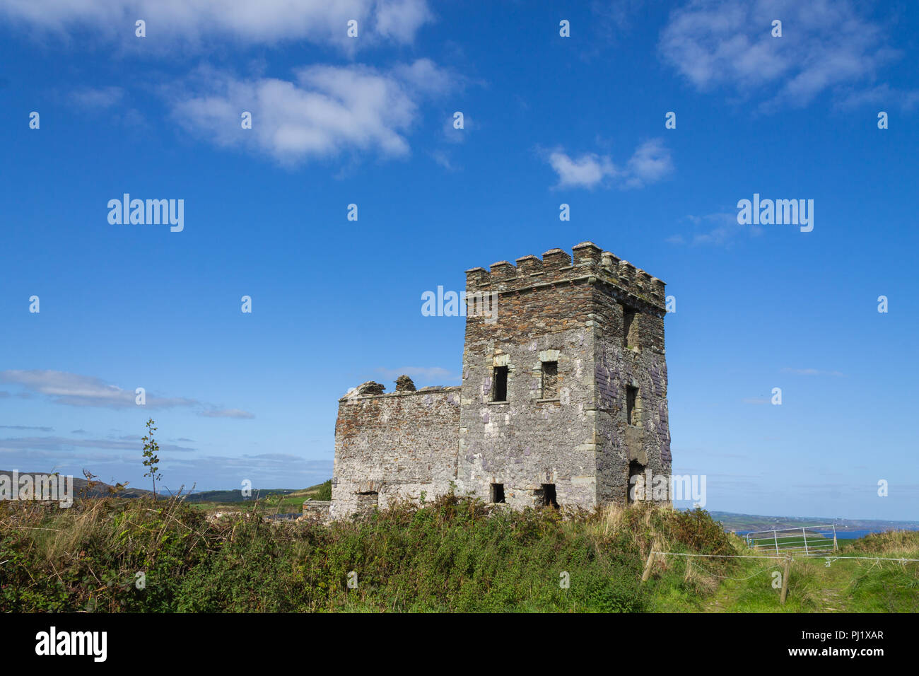 Napoleonic watch tower against a blue sky in west cork, ireland Stock Photo