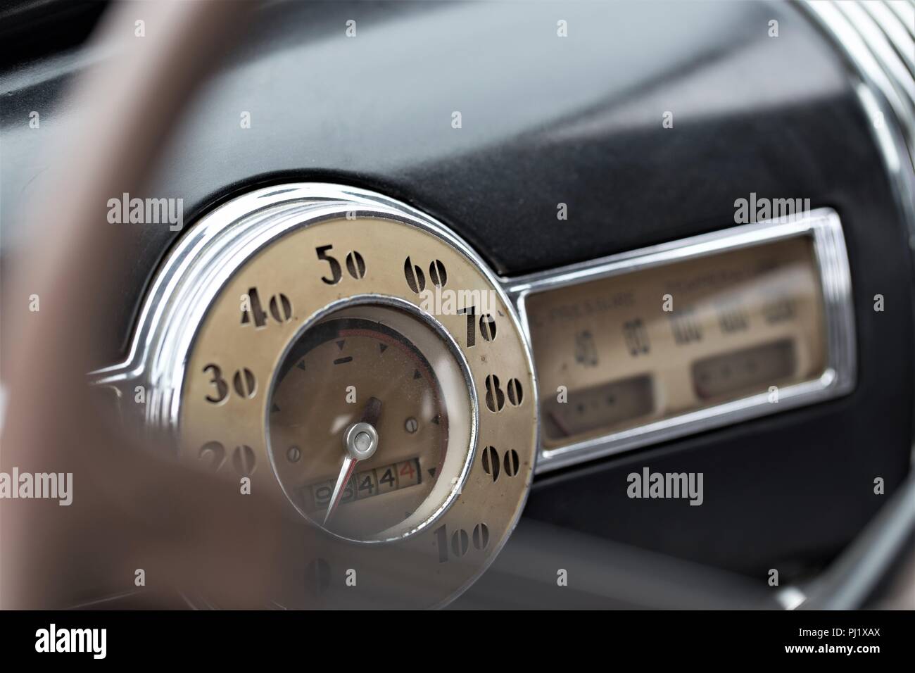 steering wheel in old car with focus on tachometer Stock Photo